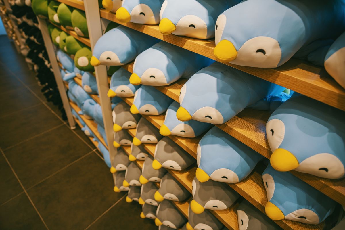 Rows of cheerful blue bird plush toys